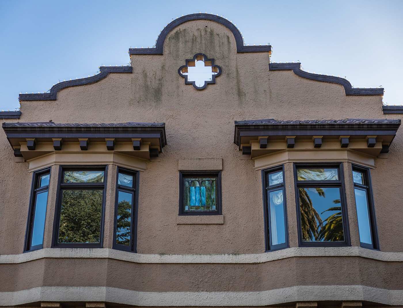 A building facade with ornate arched windows and tile detail