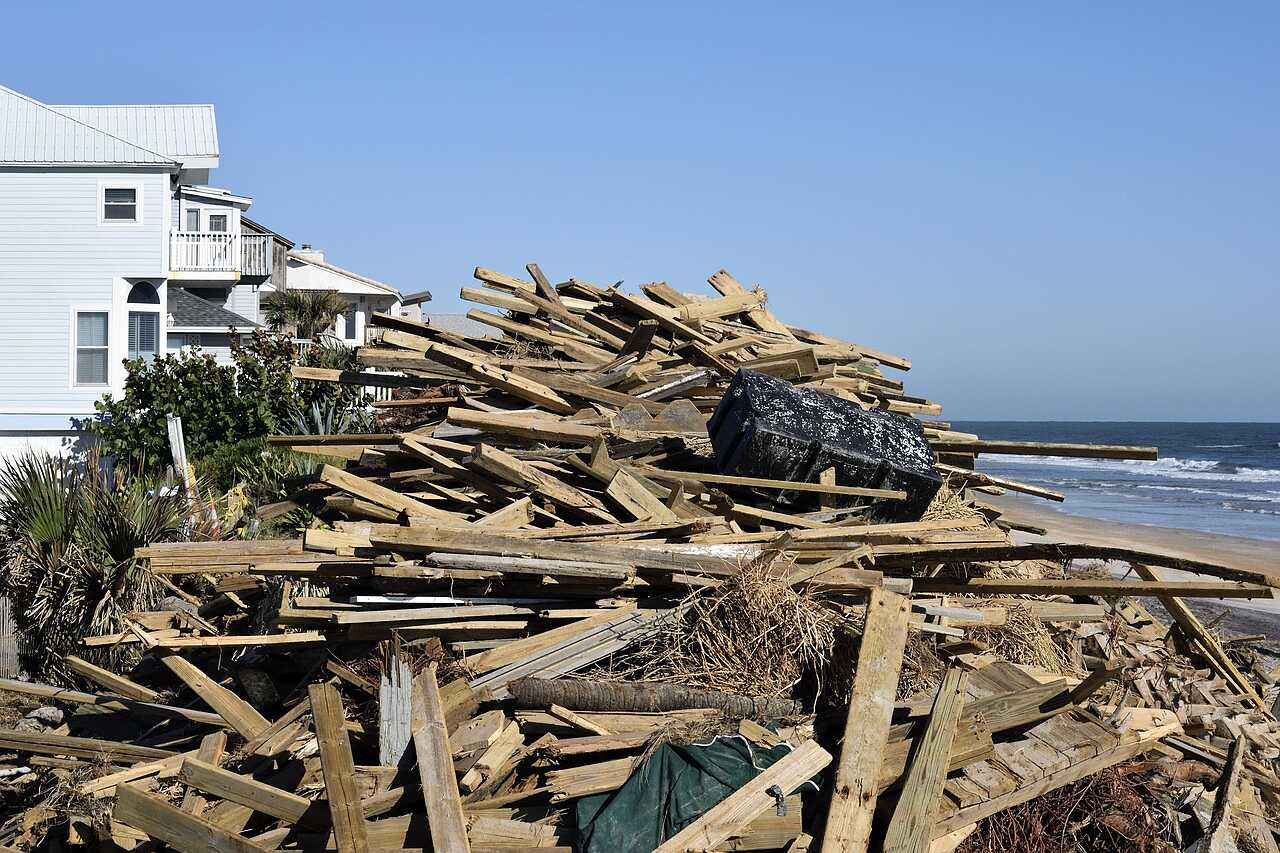 Storm debris piled along a shoreline
